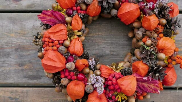 Wreath of autumn plants and berries.autumn wreath with orange physalis. florist shop