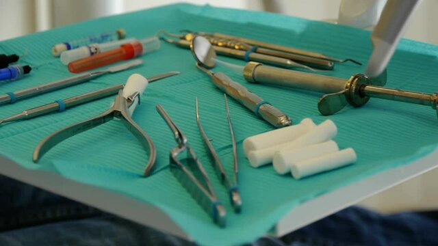 syringes and tools of a dentist on a tray, camera panning