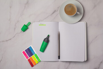 computer pen and notebook with the inscription plan.