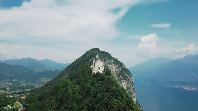 Drone shot of Santuario Di Montecastello on cliff next to Lake Garda