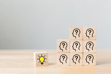 Concept creative idea and innovation. Wooden cube block with head human symbol and light bulb icon