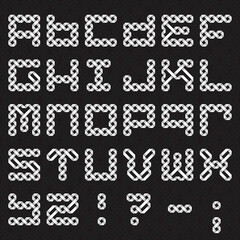 Font of intertwined paper ribbons. Alphabet of white relief letters on a black patterned background.