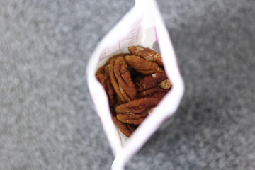 Pecan nuts in plastic bag. Directly Above.