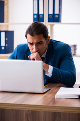 Young male employee working in the office