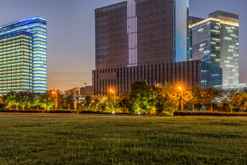 Fototapeta premium modern office buildings near meadow in midtown