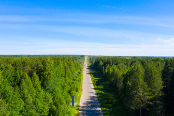 bad asphalt road with large holes top view, federal highway of the Vologda and Kostroma regions in the north of Russia.