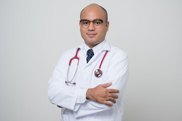 Doctor in white coat, stethoscope cross his arm look into camera isolated.on white background.