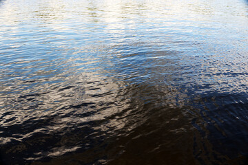 The background of the water. Reflection of the sky on the water.