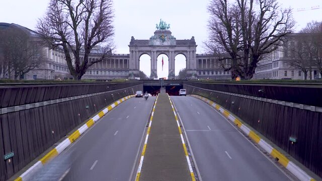 Traffic passing the Cinquantenaire arch in Brussels, Belgium during a winter's day