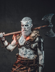 Scary fashion of chief of the night and dead dressed in armour with fur holding two handed axe on...
