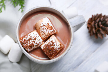 Cup of hot cacao drink with marshmallows on table