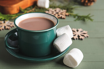 Fototapeta na wymiar Cup of hot cacao drink with marshmallows on table