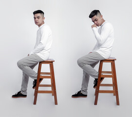 Handsome man wearing white long sleeve t-shirt was sitting on a chair with a plain background