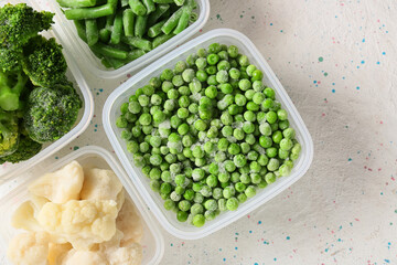 Bowls with different frozen vegetables on white background