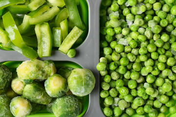 Divided box with different frozen vegetables, closeup