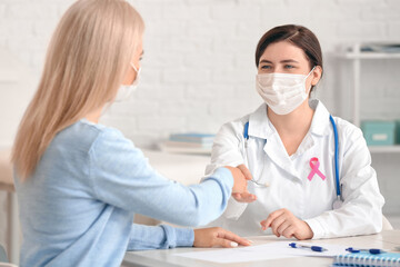 Young woman visiting doctor in clinic. Breast cancer awareness