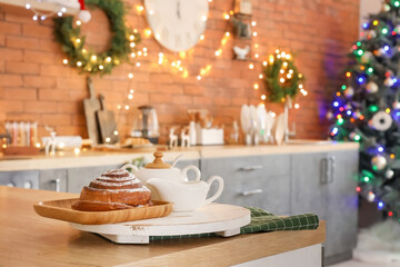 Tasty pastry on table in kitchen decorated for Christmas