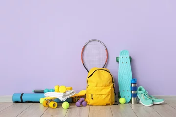 Zelfklevend Fotobehang Set of sport equipment on floor near color wall © Pixel-Shot