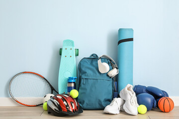 Set of sport equipment on floor near color wall