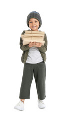 Cute African-American boy with stack of books on white background