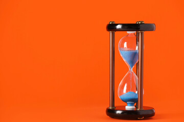 Hourglass on color background. Time management concept
