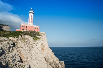 Fototapeta na wymiar Seascape with a lighthouse on the coast and the sea.