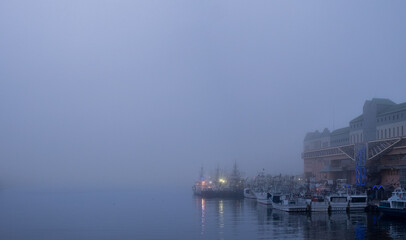 Fototapeta na wymiar Foggy harbor view around Nusamaibashi Bridge in Kushiro City