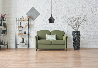 Modern white brick wall background, green and grey sofa, black f