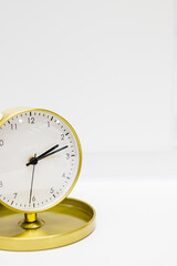 Old alarm clock with ten minutes past two. Date and time reminder or deadline concept, small clock on white background, counting down to holiday, vacation or end of month.Time Management. Copy space