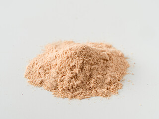 Lucuma powder heap isolated on white background. Natural low glycemic sweetener Pouteria Lucuma, top view or flat lay. Isolated with clipping path.