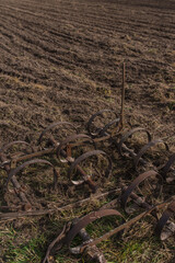 Antique cultivator on the field. Old methods of agriculture.