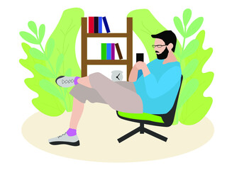 A young man sits in a chair and stares at the phone. Businessman works at home , talking on the phone online.