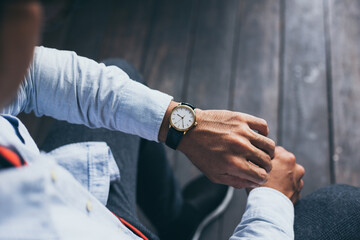 man fashionable wearing stylish looking at luxury watch on hand check the time at workplace.concept for managing time organization working,punctuality,appointment - obrazy, fototapety, plakaty