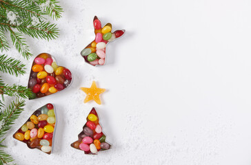 Christmas composition on white paper background, figures Angel, heart, bell and Christmas tree, fir branches, minimalism, space for text