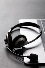 Office desk with headset and laptop