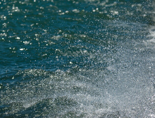 drops and splashes of water on blue background