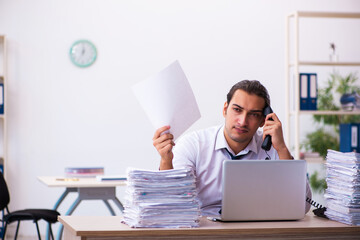 Young male employee unhappy with excessive work