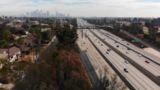 Aerial static view of Interstate 10 with traffic looking at downtown Los Angeles, sunny day with clouds, in Los Angeles, California, USA