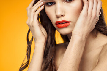 beautiful brunette red lips bare shoulders skin care yellow background