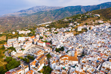 Fototapeta na wymiar Picturesque mountain landscape with Spanish town of Competa on slopes of Sierra de Tejeda in province of Malaga on sunny autumn day.