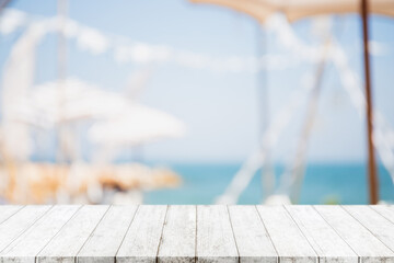 Empty wood table top and blurred summer beach in tropical resort banner background - can used for...