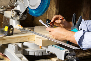 Carpenter work with circular saw for cutting wood bar, the man sawed bars, construction and home renovation. Carpenter work concept