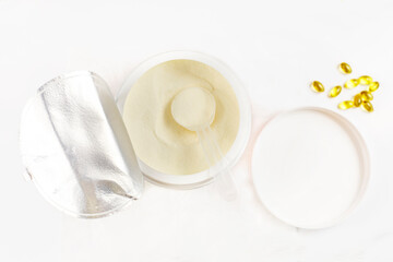 cologen powder for face rejuvenation in a serving spoon on a white background