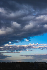 Obraz premium Dramatic dark cloudy sky over the horizon, natural blue background.