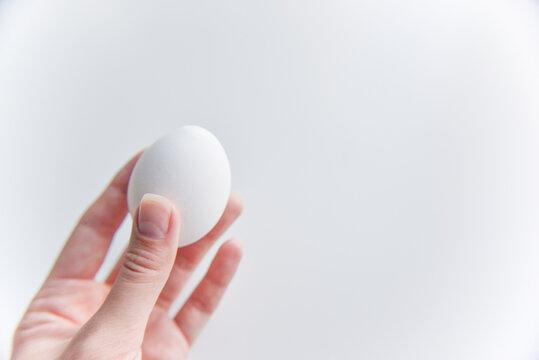 selective focus at the white egg in the hand