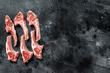 Raw lamb chops, Rack of Lamb. Organic meat steak. Black background. Top view. Copy space