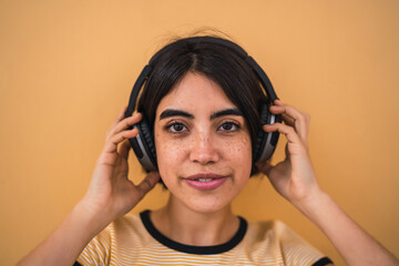 Young woman listening music with headphones.