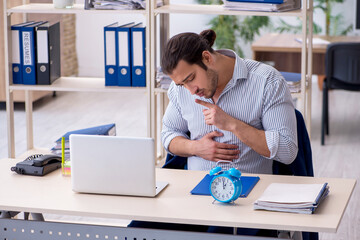 Hungry male employee waiting for food in time management concept