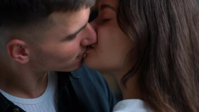 Young woman and man kiss passionately. Close-up. Romantic couple of lovers