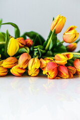 Lovely greeting card with tulips for Mothers day, wedding or happy event. White background. Top view. Copy space